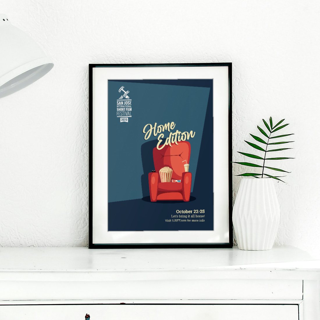 The 2020 San Jose International Short Film Festival “Home Edition” poster as a matted, framed print on a white dresser