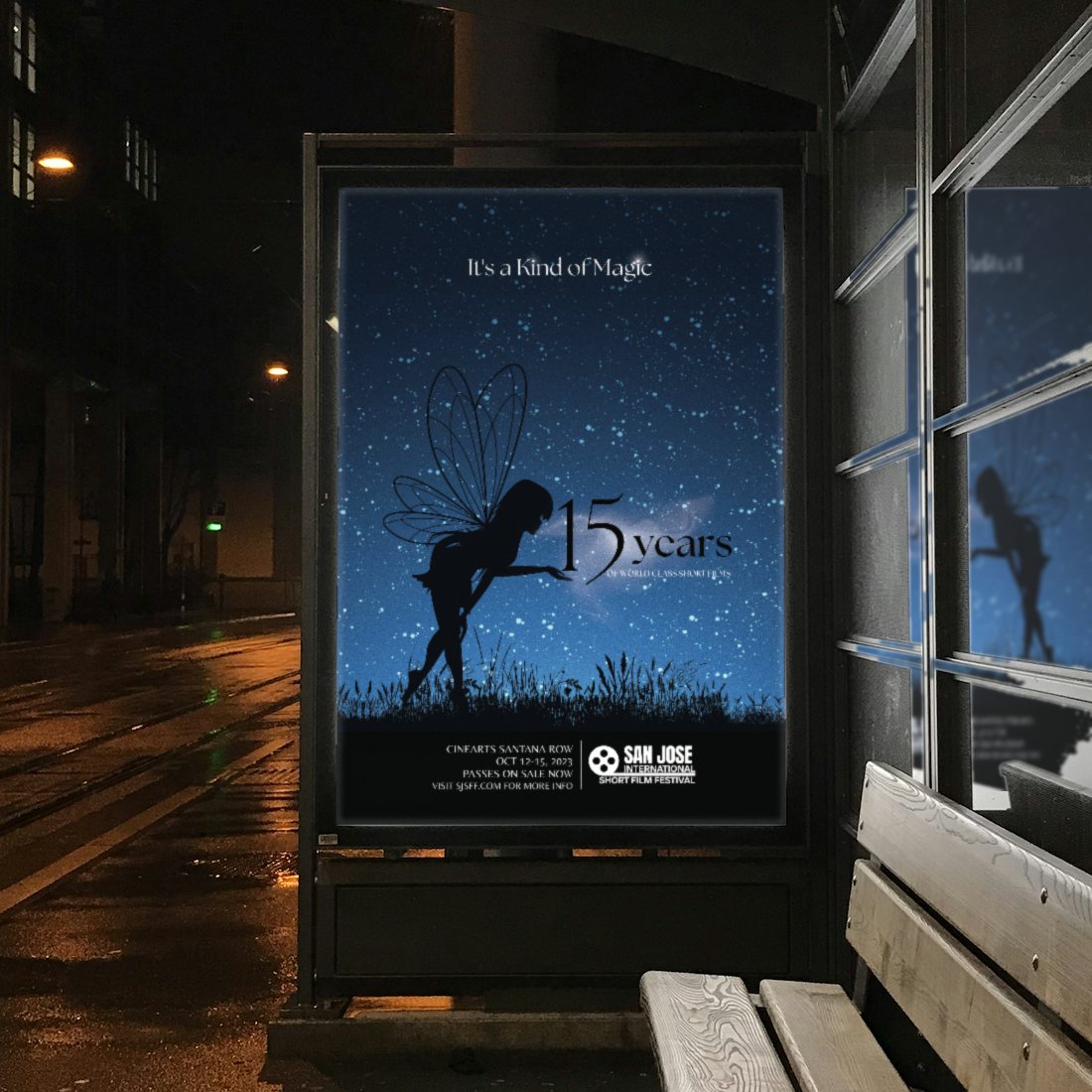 The 2023 San Jose International Short Film Festival “It’s a Kind of Magic” poster glowing in a tram stop ad panel at night