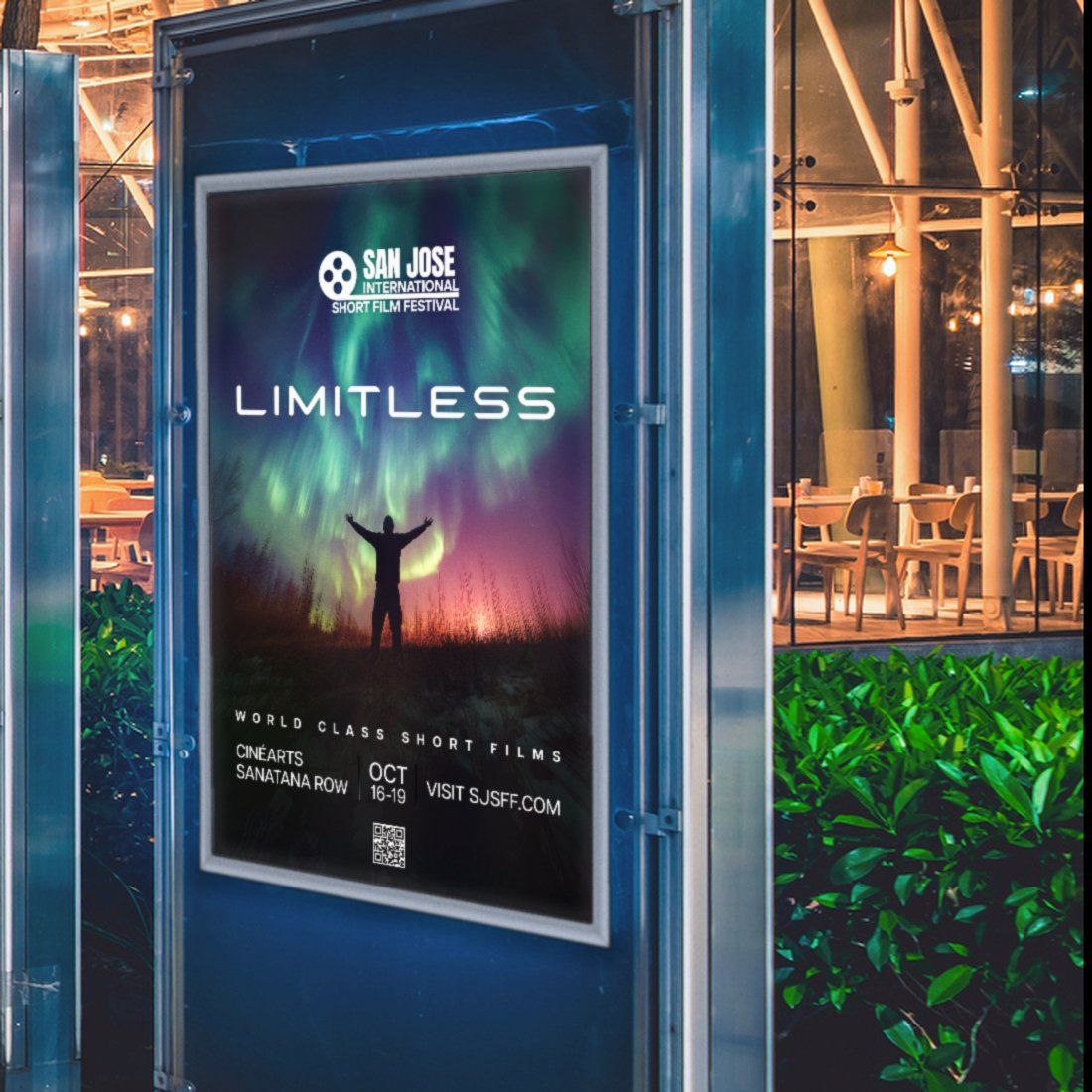The 2025 San Jose International Short Film Festival “Limitless” poster in a silver frame inside a backlit outdoor poster case at night