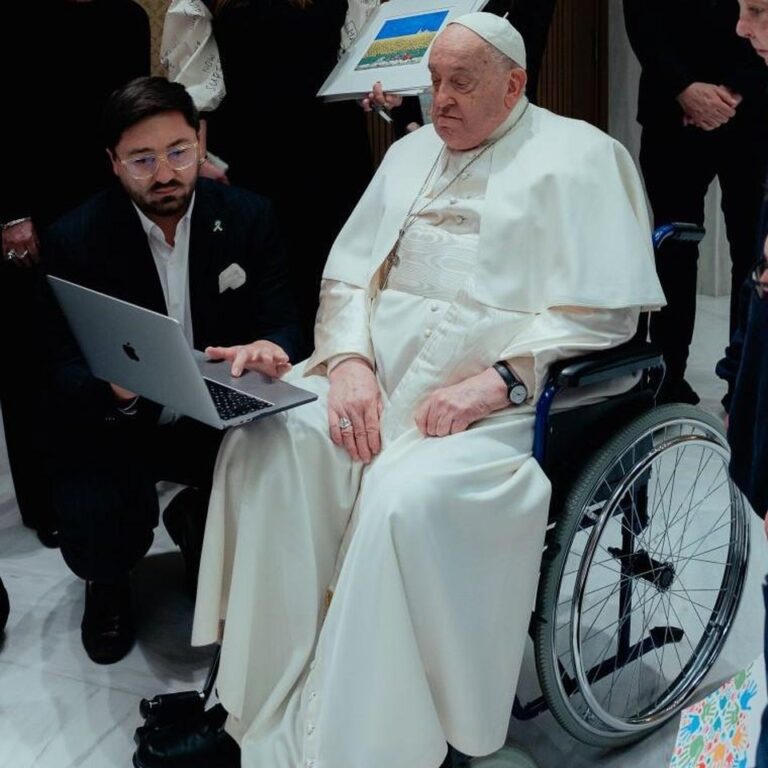 Pope Francis watching Romchyk on a laptop at a special screening at the Vatican