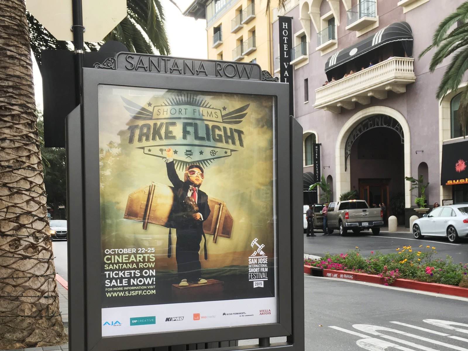 A San Jose International Short Film Festival “Take Flight” poster on a Santana Row street sign display