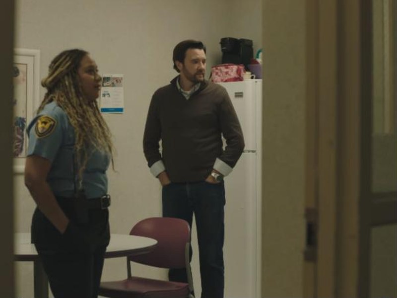A security guard and a man in a break room in Elevate