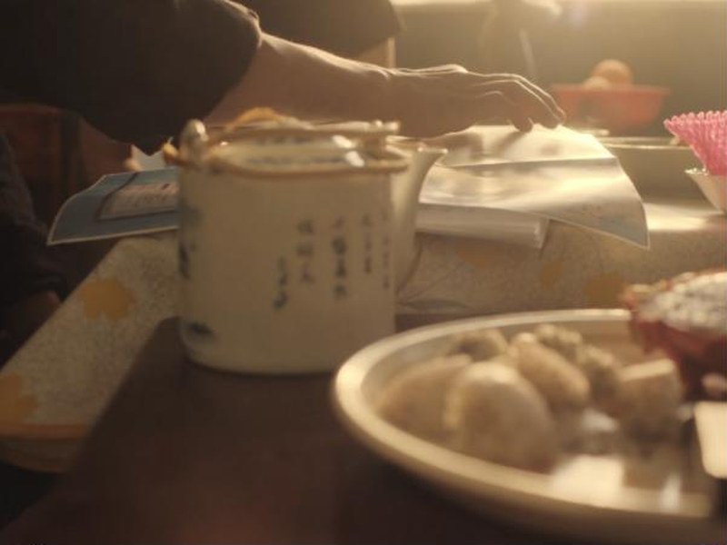 A teapot and a plate of food on a sunlit table in Freedom Swimmer