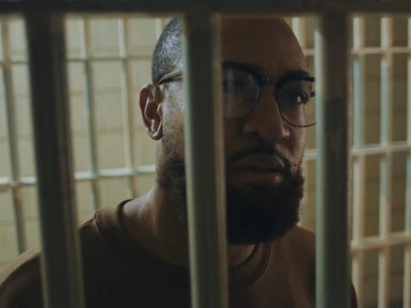 An inmate behind bars in Infraction