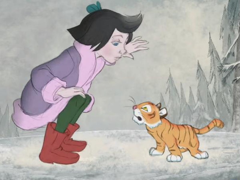 Sarah meets a tiger cub in the snow in Mushka