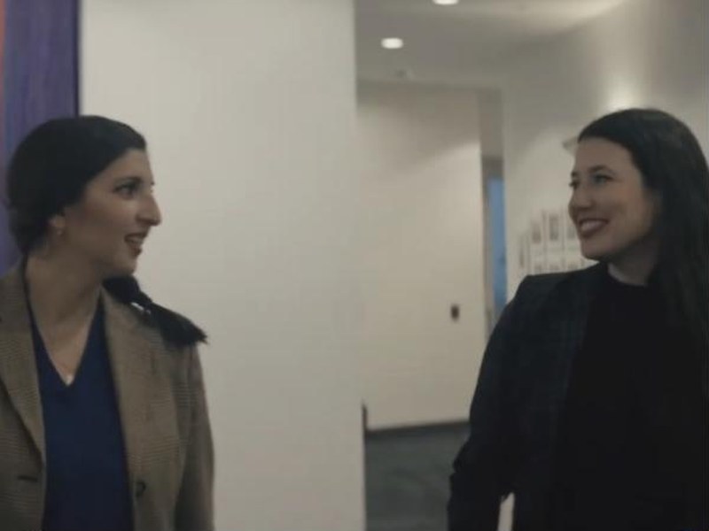 Two women talking in a hallway in Not the Science Type