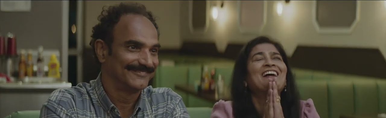 Sid’s parents laugh in a diner booth in Coming Out With the Help of a Time Machine